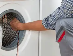 Dryer repair technician diagnosing and servicing a clothes dryer in Eugene, OR