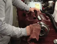 Vacuum repair technician cleaning and servicing a vacuum motor in Eugene, OR