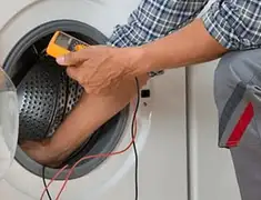 Washing machine repair technician testing a front-load washer with diagnostic tools in Eugene, OR